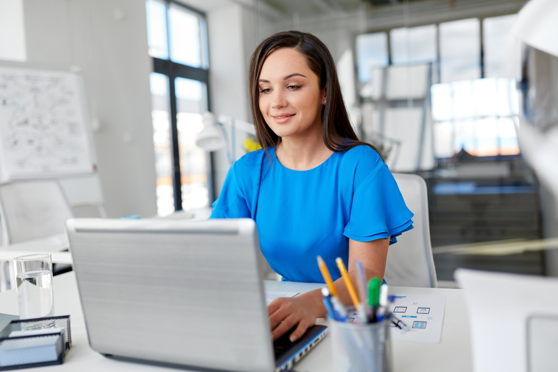 Businesswoman with Laptop Working at Office